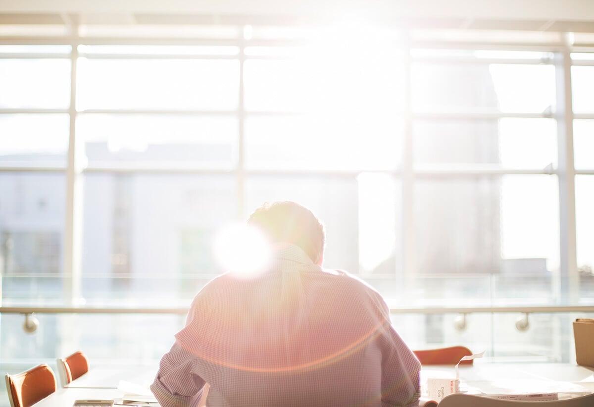 Woman balancing in a handstand on a rock by the ocean, symbolizing balance, energy, and thriving with Tech To Thrive personal coaching.